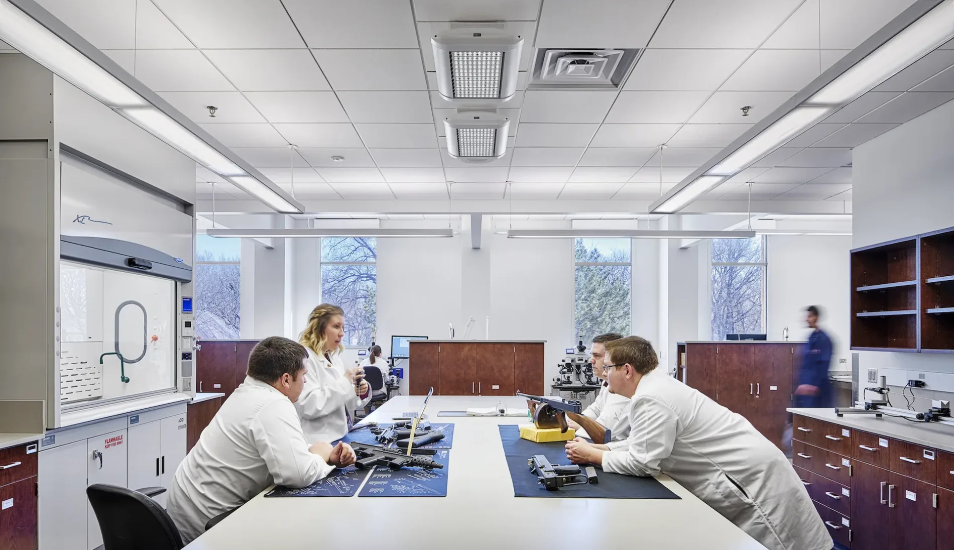 Associates discussing firearms at the Kansas Bureau of Investigation Forensic Science Center