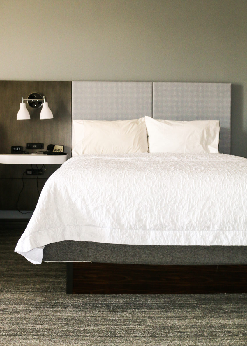 A photo of a bed inside a hotel room at Hampton Inn KC