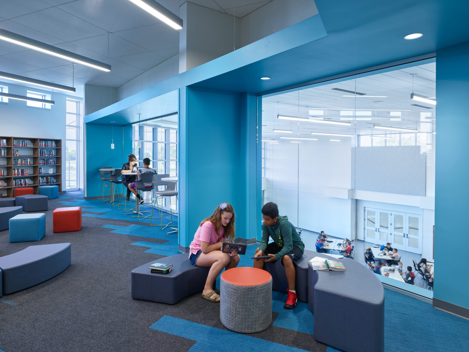 Students reading in room overlooking lunch room at Olathe USD 233 Summit Trail Middle School