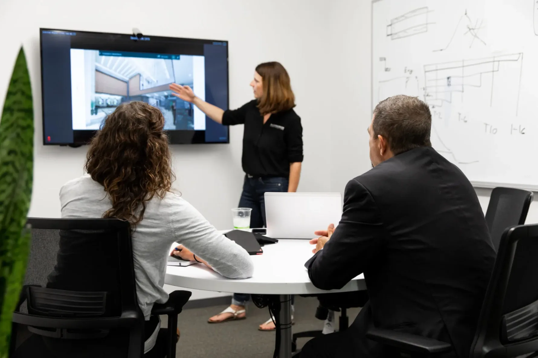 Three McCownGordon Construction associates collaborating during a meeting in the office