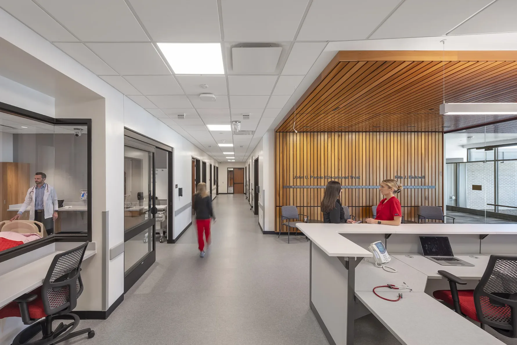 Pitt State students talking at the nurses desk in the simulation hospital, built by McCownGordon