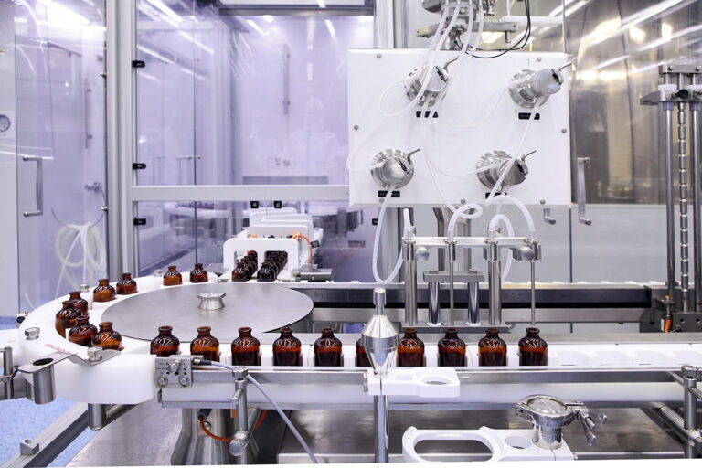 Sterile bottles and ampoules on the dispensing line at a pharmaceutical manufacturing facility