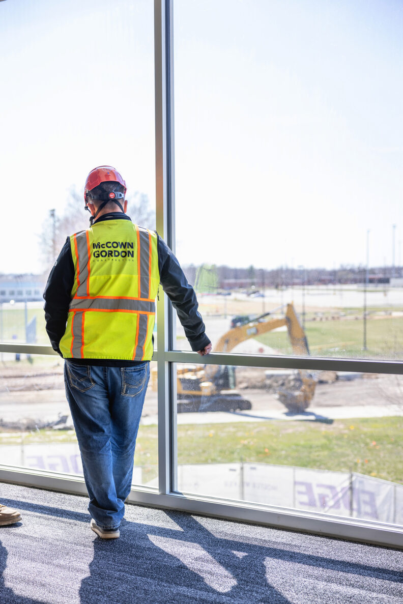 McCownGordon worker looks outside of project site window.