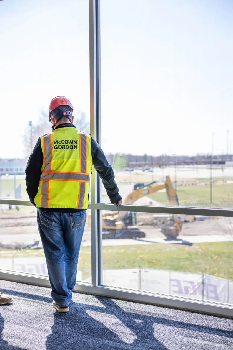 McCownGordon worker looks outside of project site window.