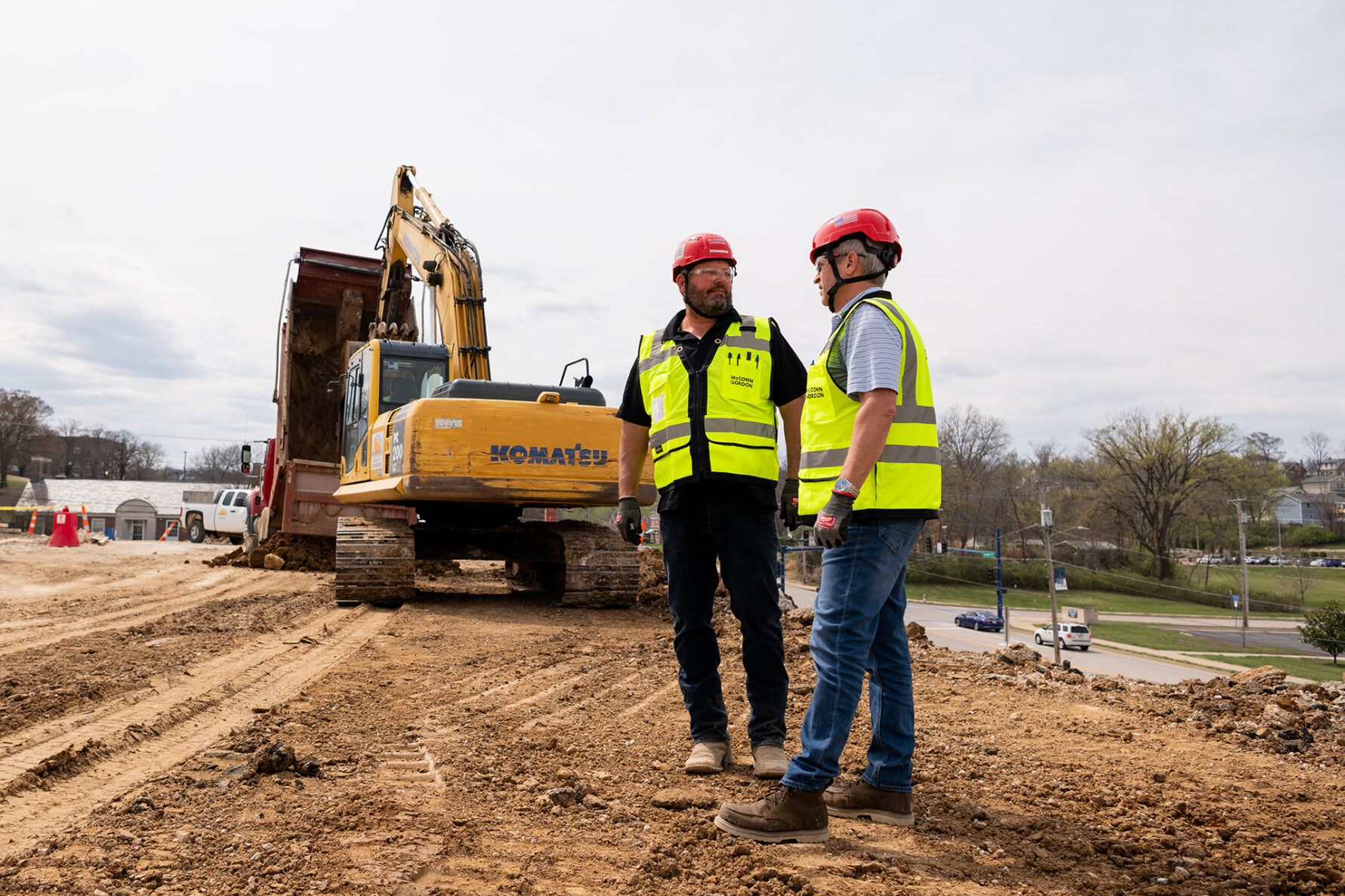 McCownGordon construction workers discuss plans on project site.