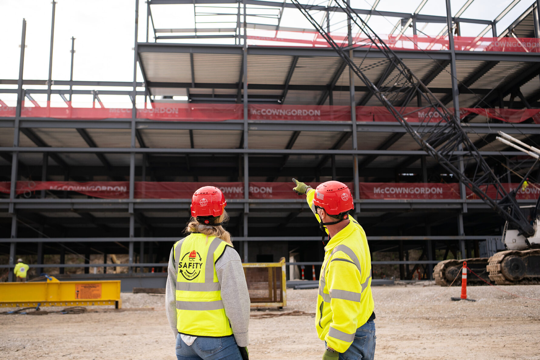 Two McCownGordon associates point to jobsite.