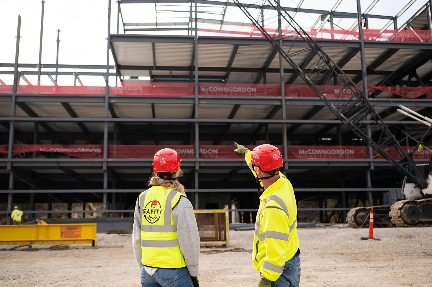 Two McCownGordon associates point to jobsite.